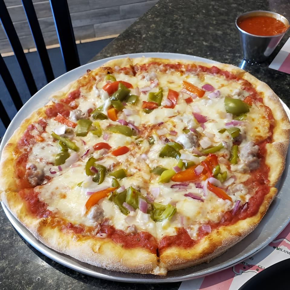 Luca Trattoria & Pizzeria's pizza with sausage, green and red peppers, and red onions.